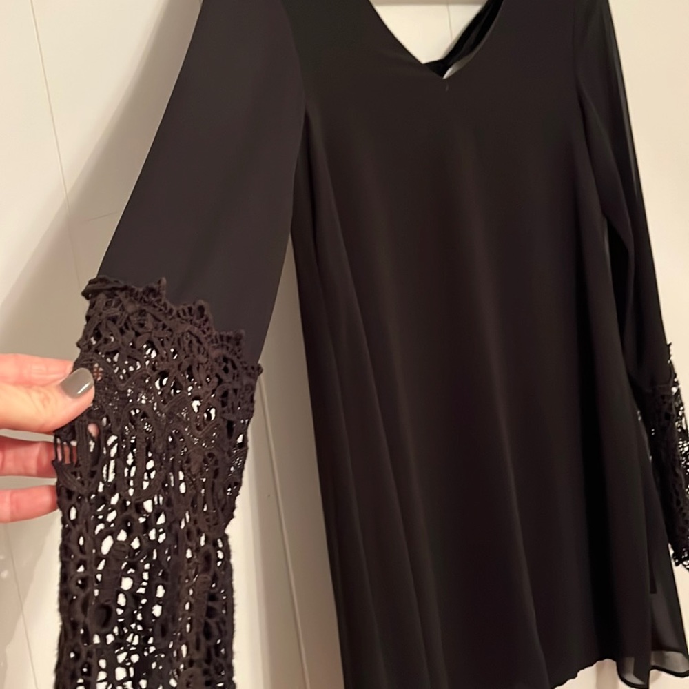Black with lace on the sleeve mid length dress . Velvet tie in the back.